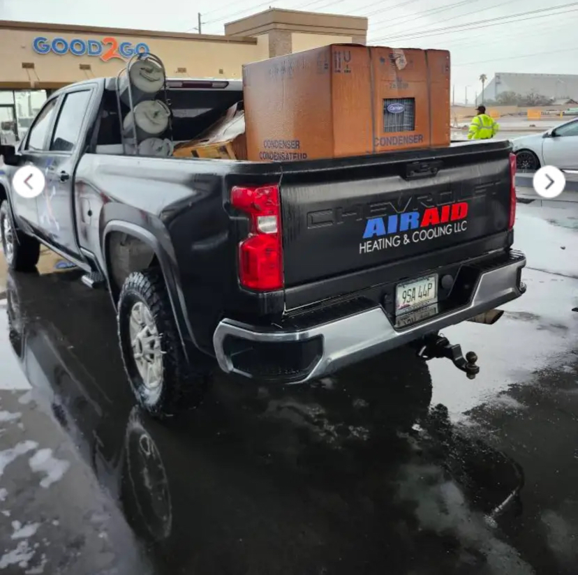 AirAid Heating and Cooling service truck at a job site